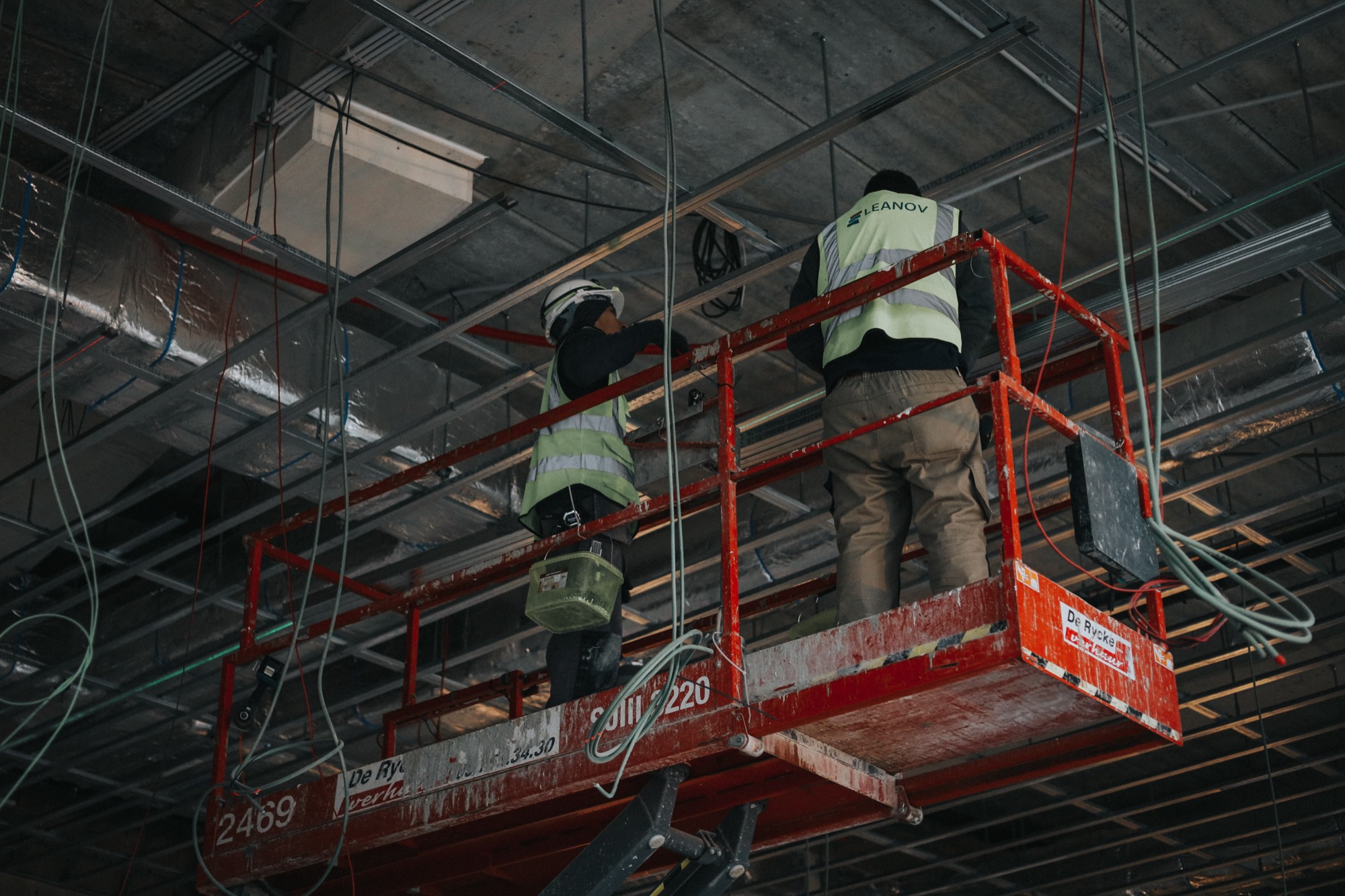 Operário LEANOV em plataforma elevatória a montar a estrutura metálica do teto